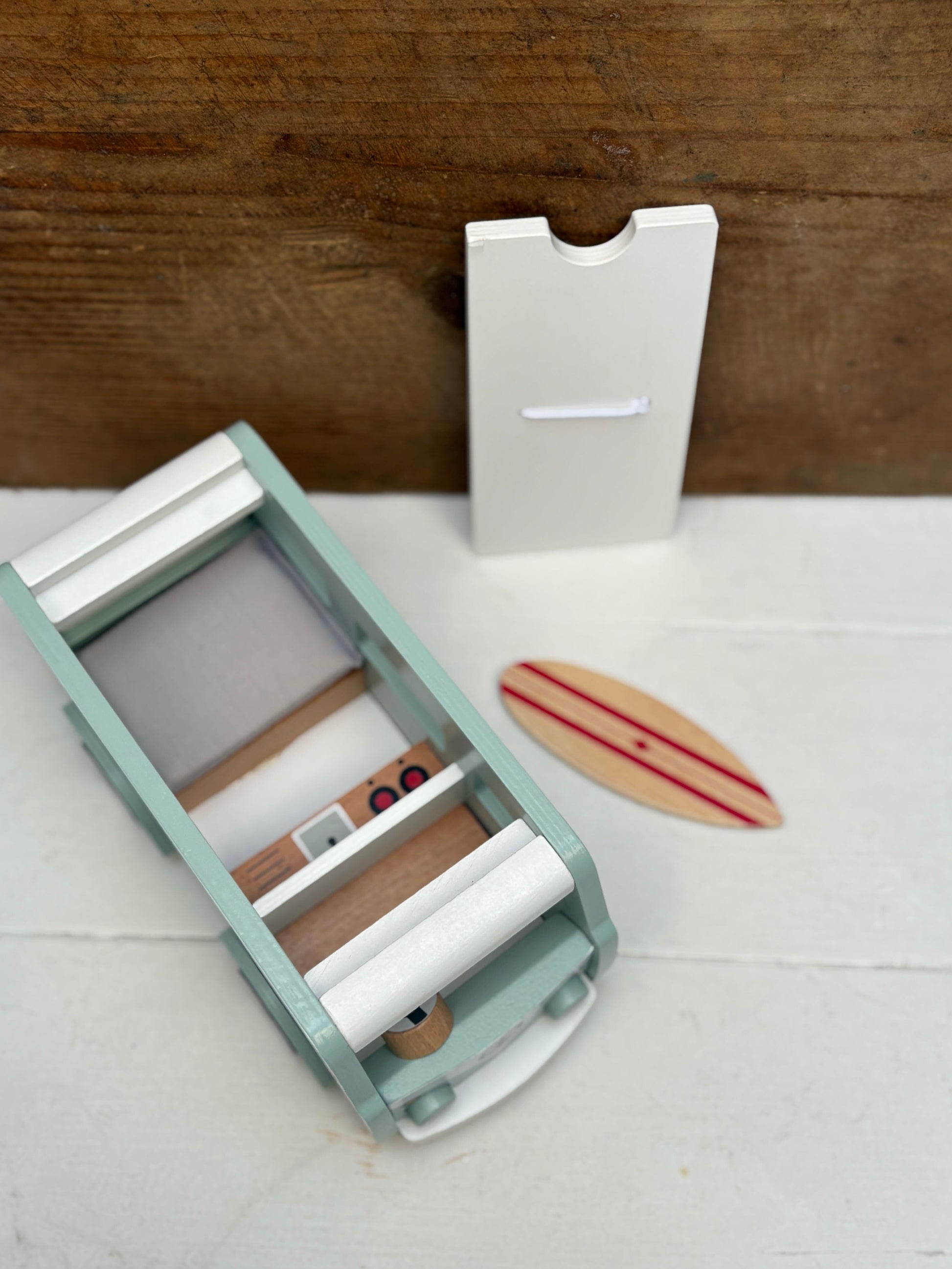Small kitchen appliance on a white surface with a wooden background