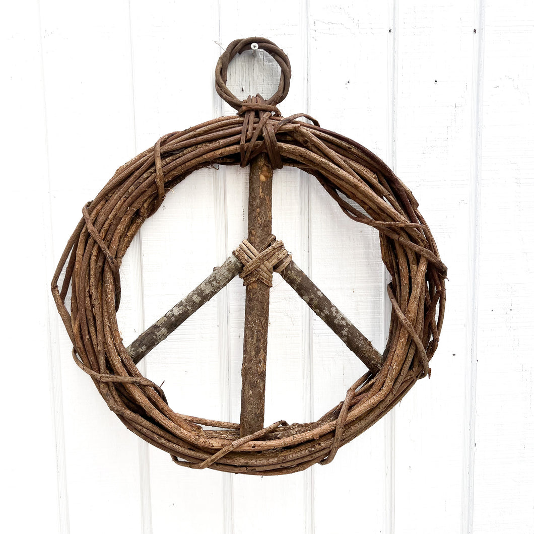 brown vine twig wreath in shape of a peace sign