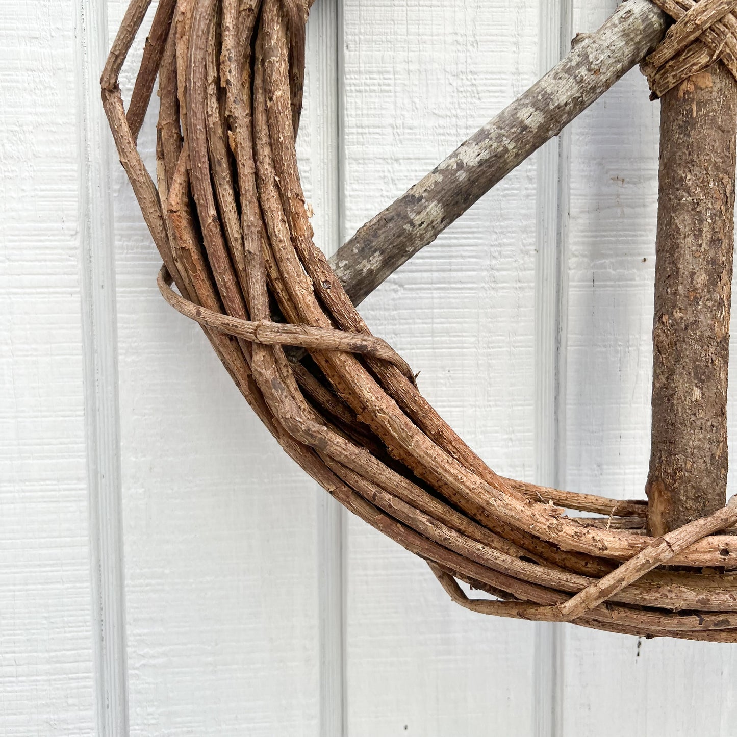 brown vine twig wreath in shape of a peace sign