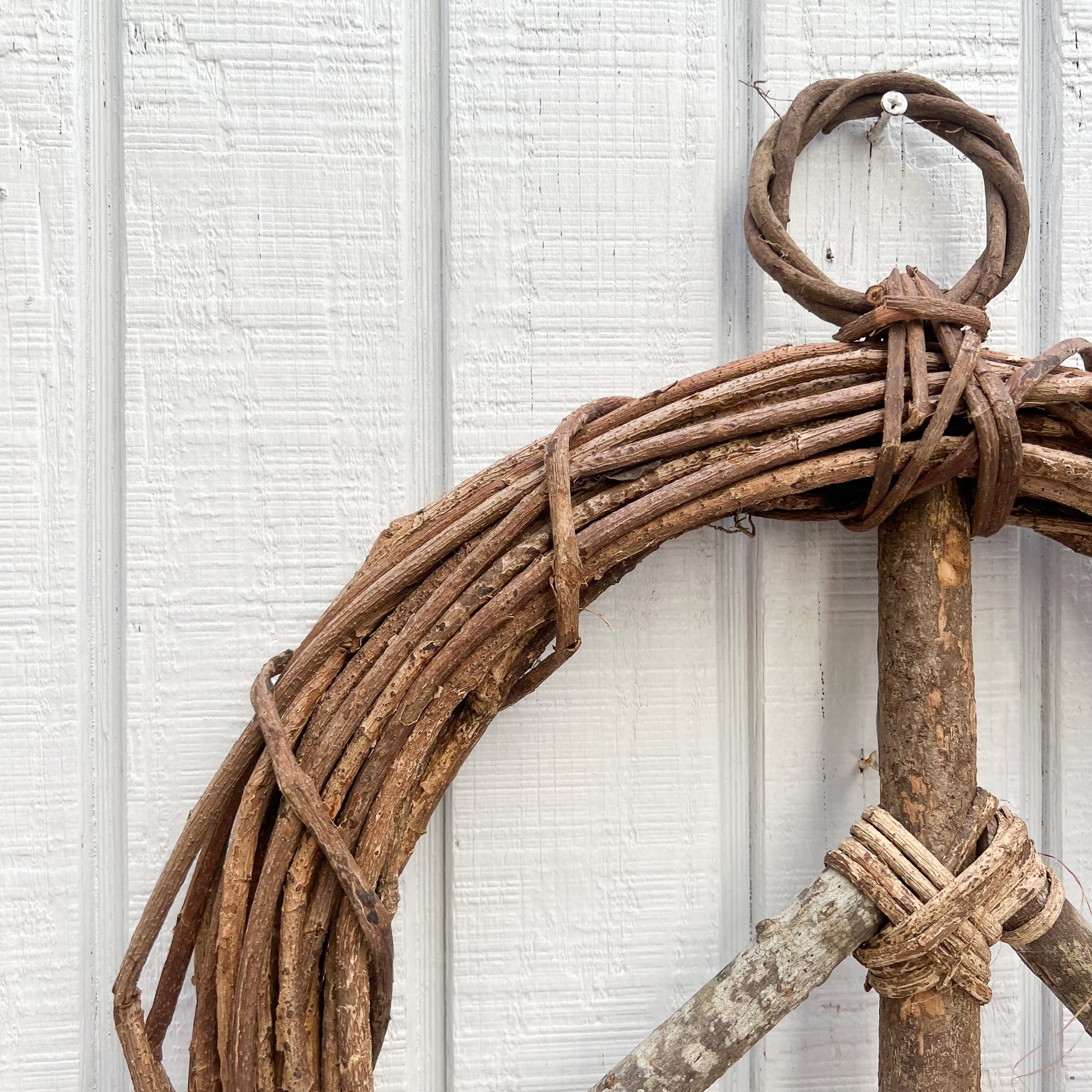 brown vine twig wreath in shape of a peace sign