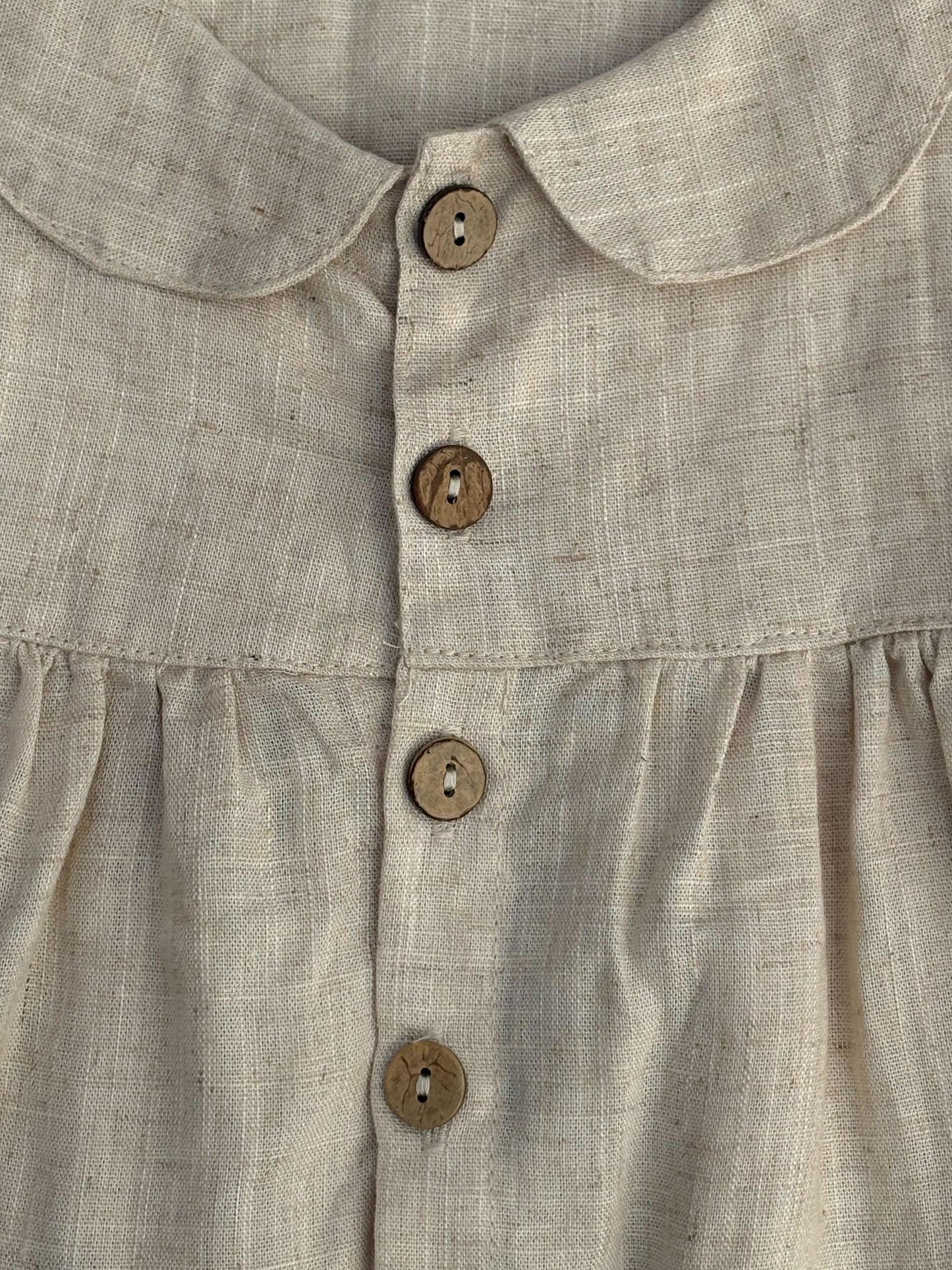 Close-up of a beige shirt with button details