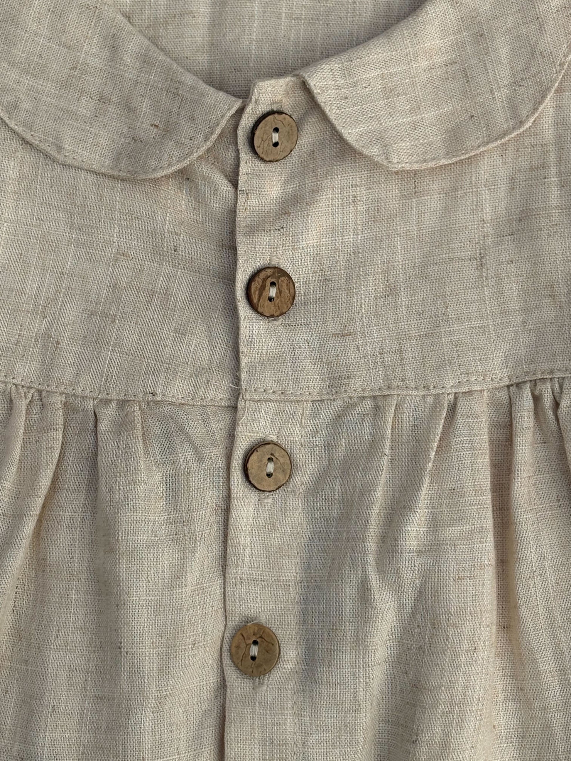 Close-up of a beige shirt with button details