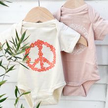 Load image into Gallery viewer, cream colored onesie with orange floral peace sign