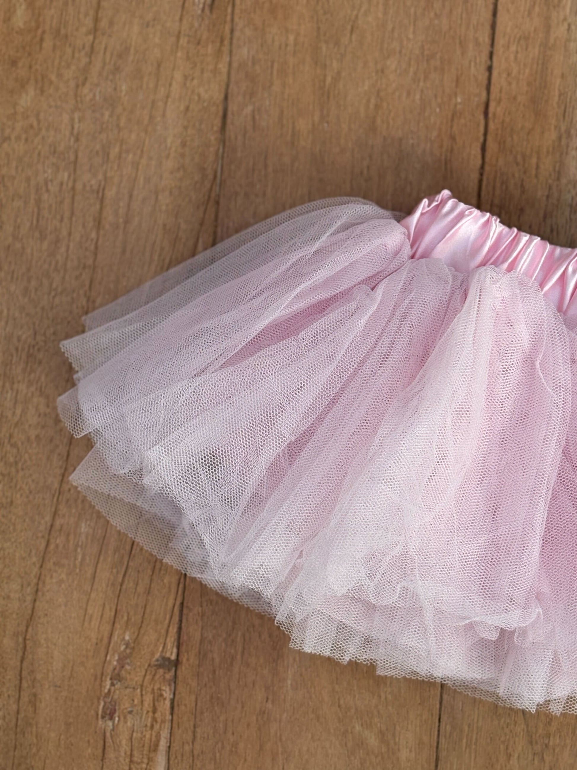 Pink tutu skirt on a wooden floor