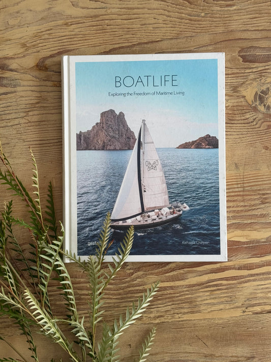 Book titled 'BOATLIFE' on a wooden surface with a sailboat cover