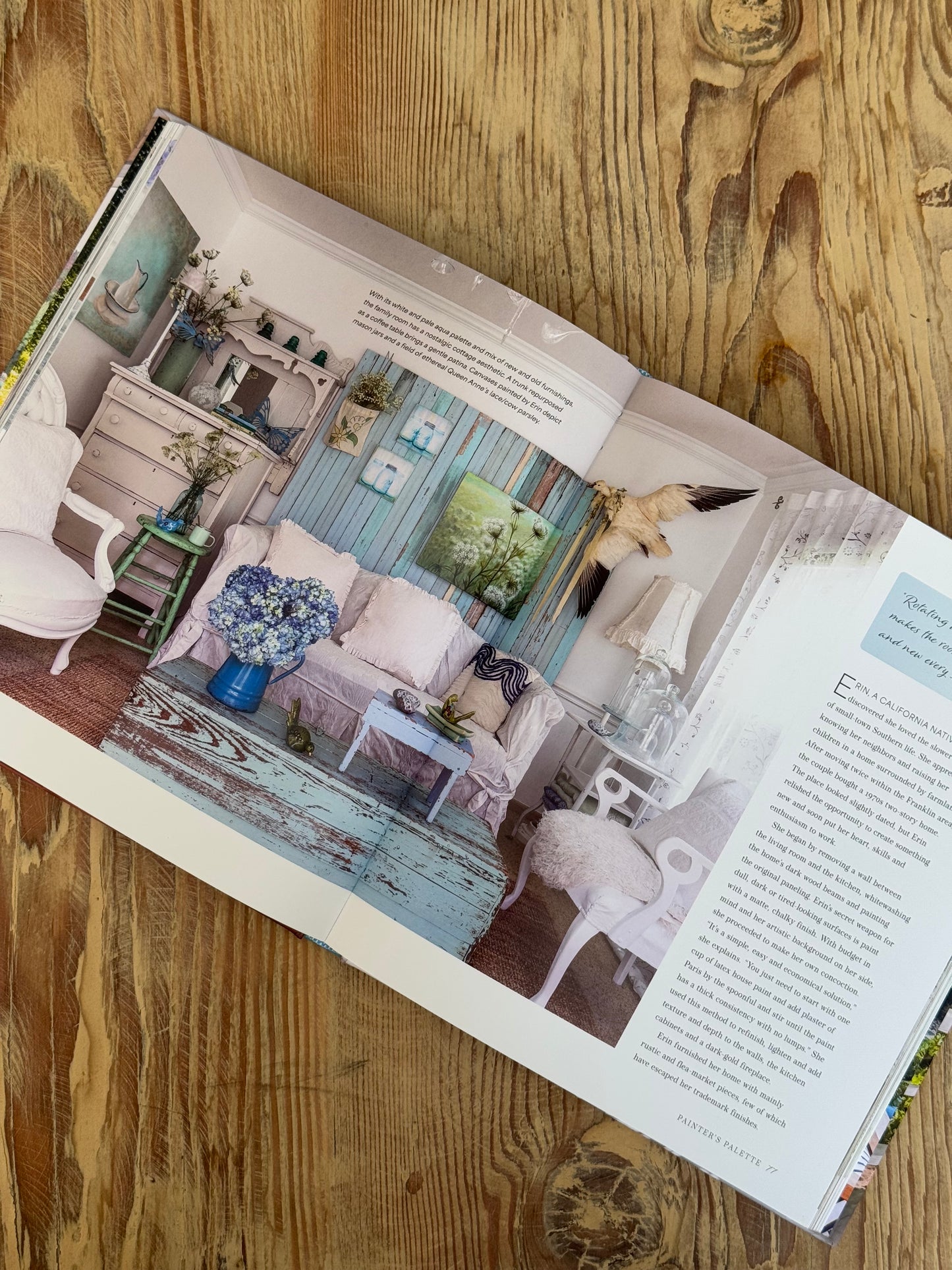 Open book showing a room layout design on a wooden surface