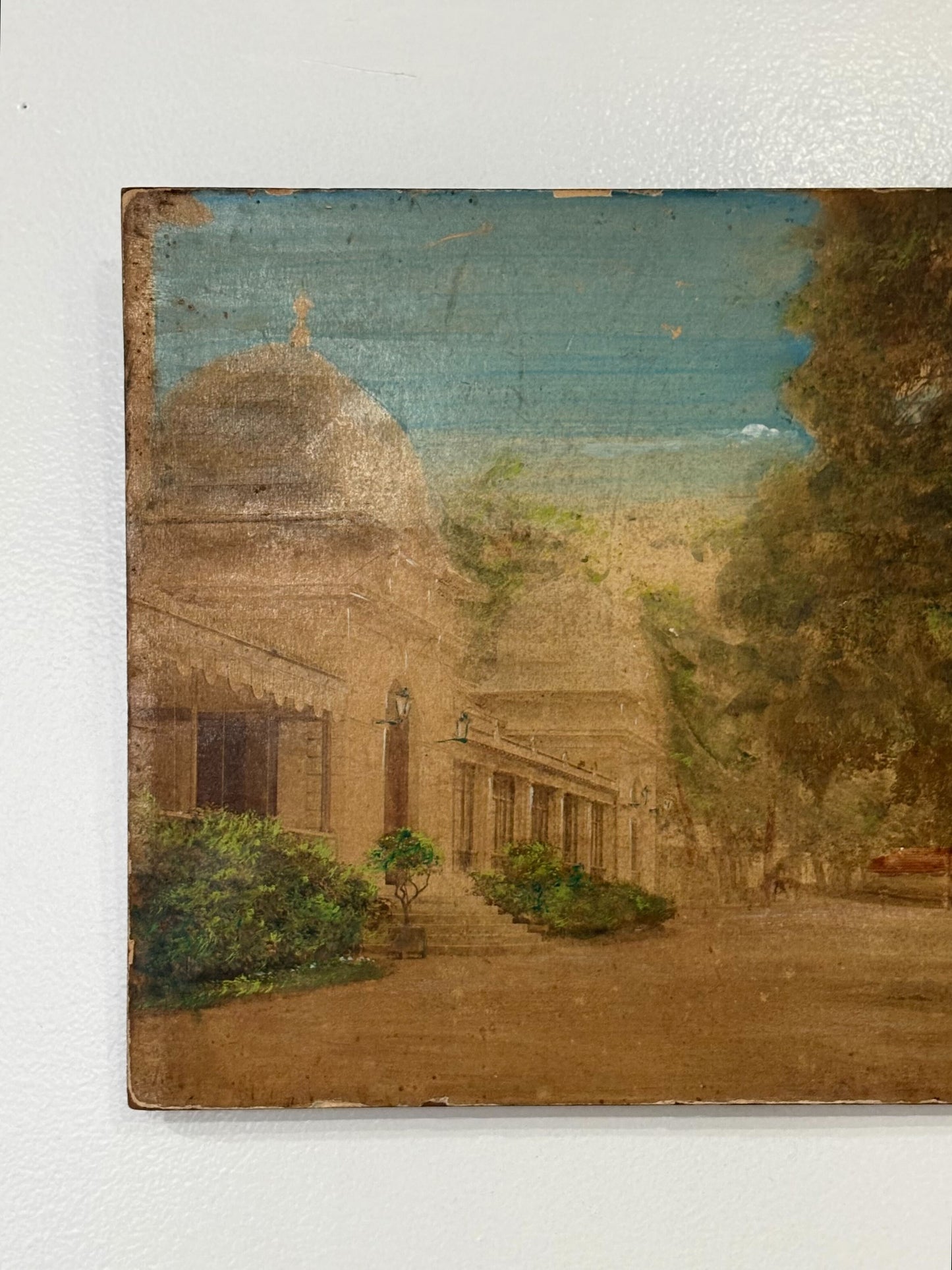 Painting of a domed building with a garden on a white wall