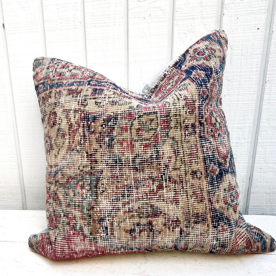Turkish rug pillow with cream, red, blue and green colors