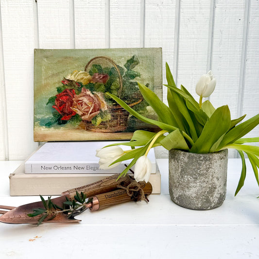 still life oil painting of a brown basket with different colored roses