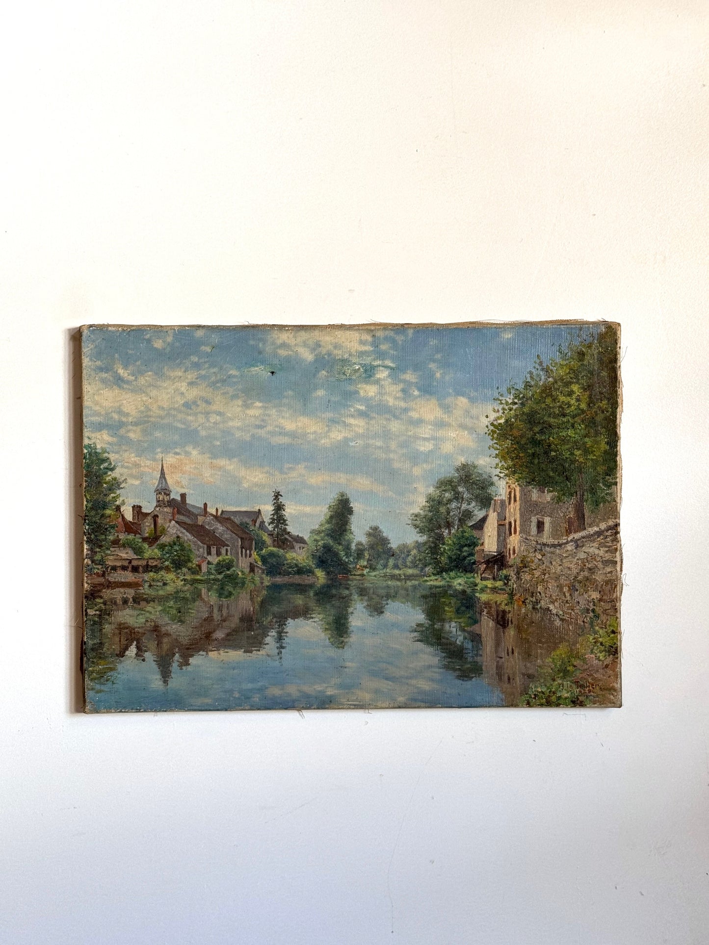 Painting of a landscape with a river and buildings on a white wall