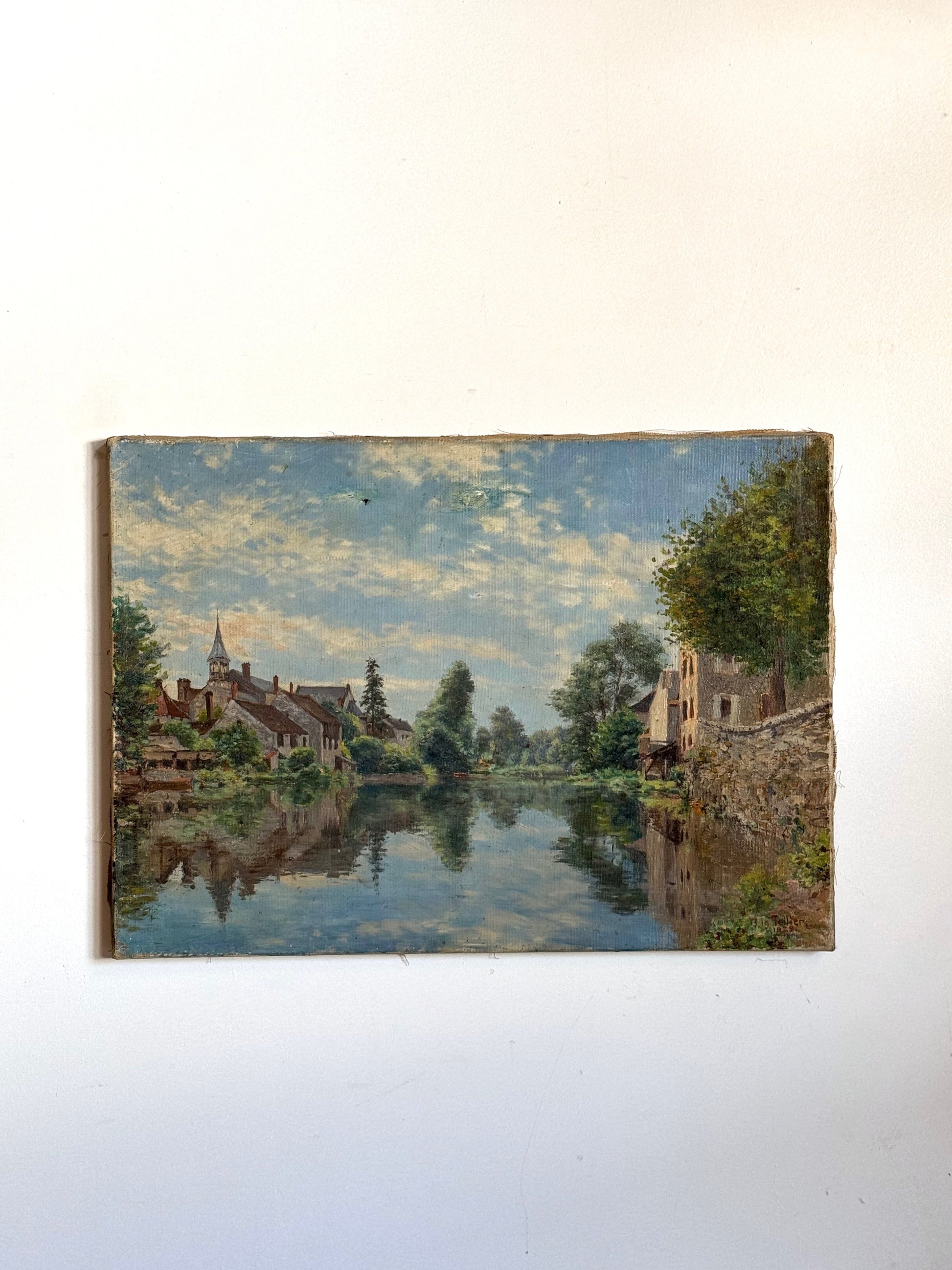 Painting of a landscape with a river and buildings on a white wall