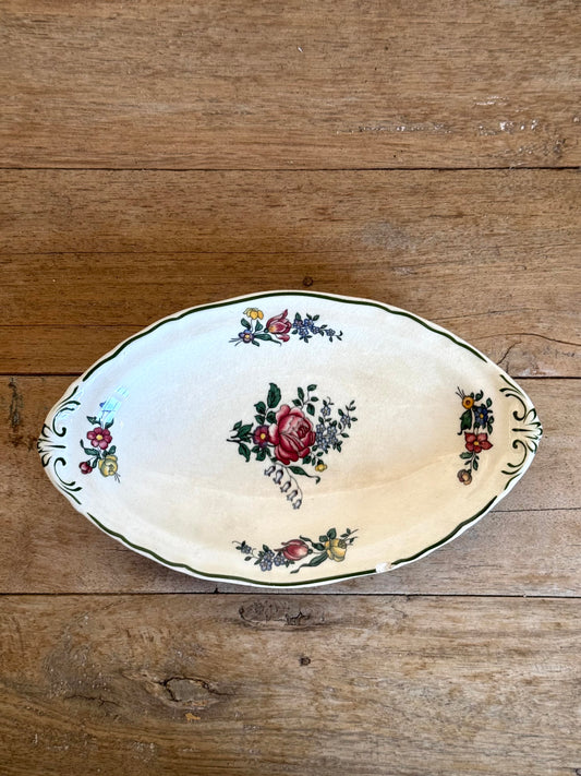 Decorative ceramic plate with floral patterns on a wooden surface