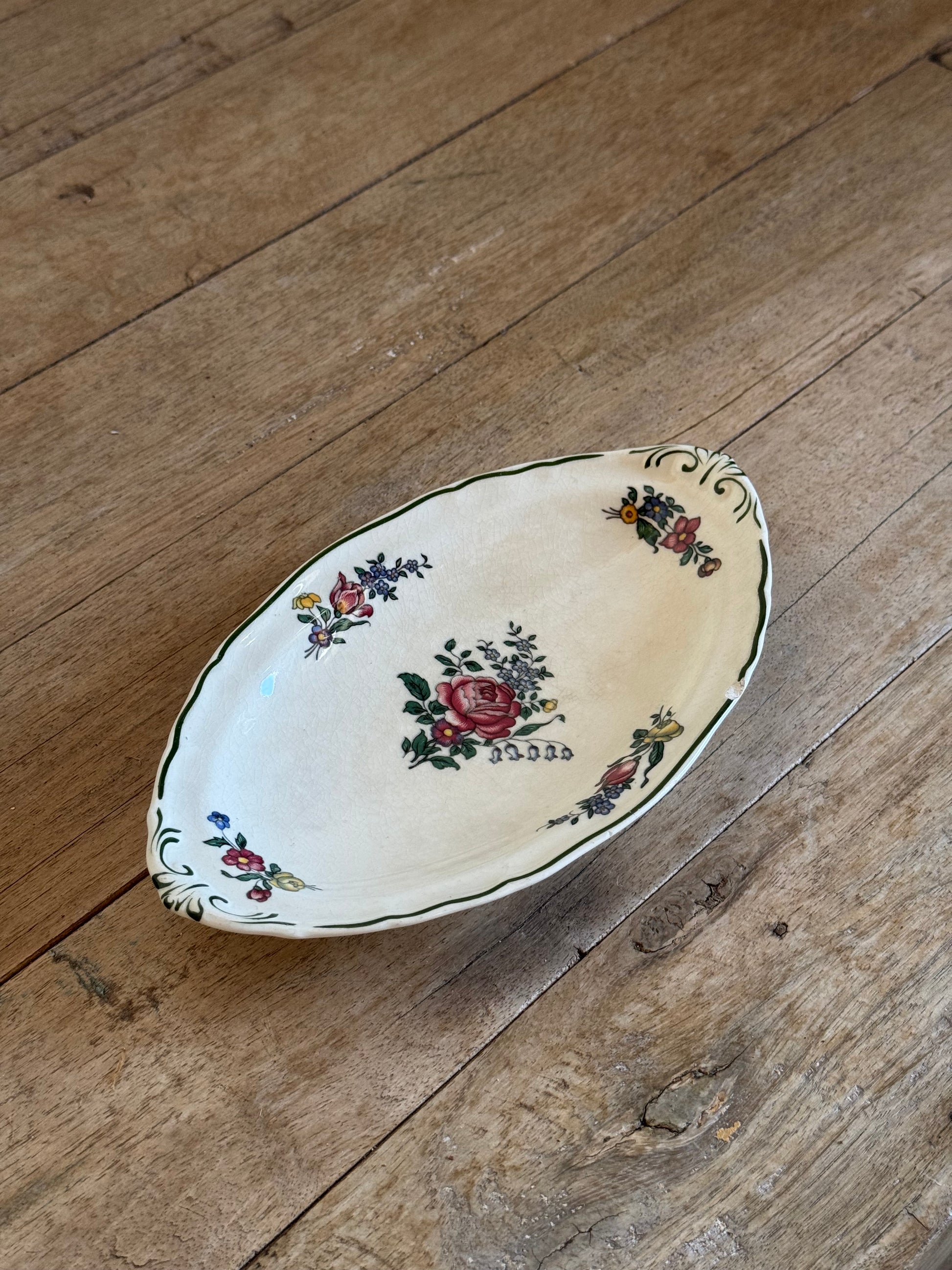 Decorative ceramic plate with floral patterns on a wooden surface