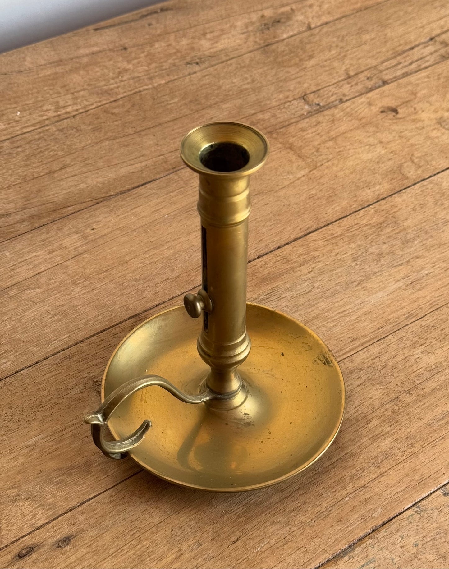 Brass candle holder on a wooden surface