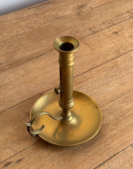 Brass candle holder on a wooden surface