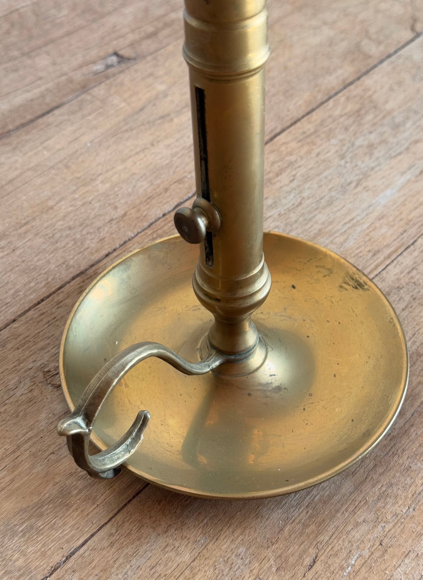 Brass candlestick holder on a wooden surface
