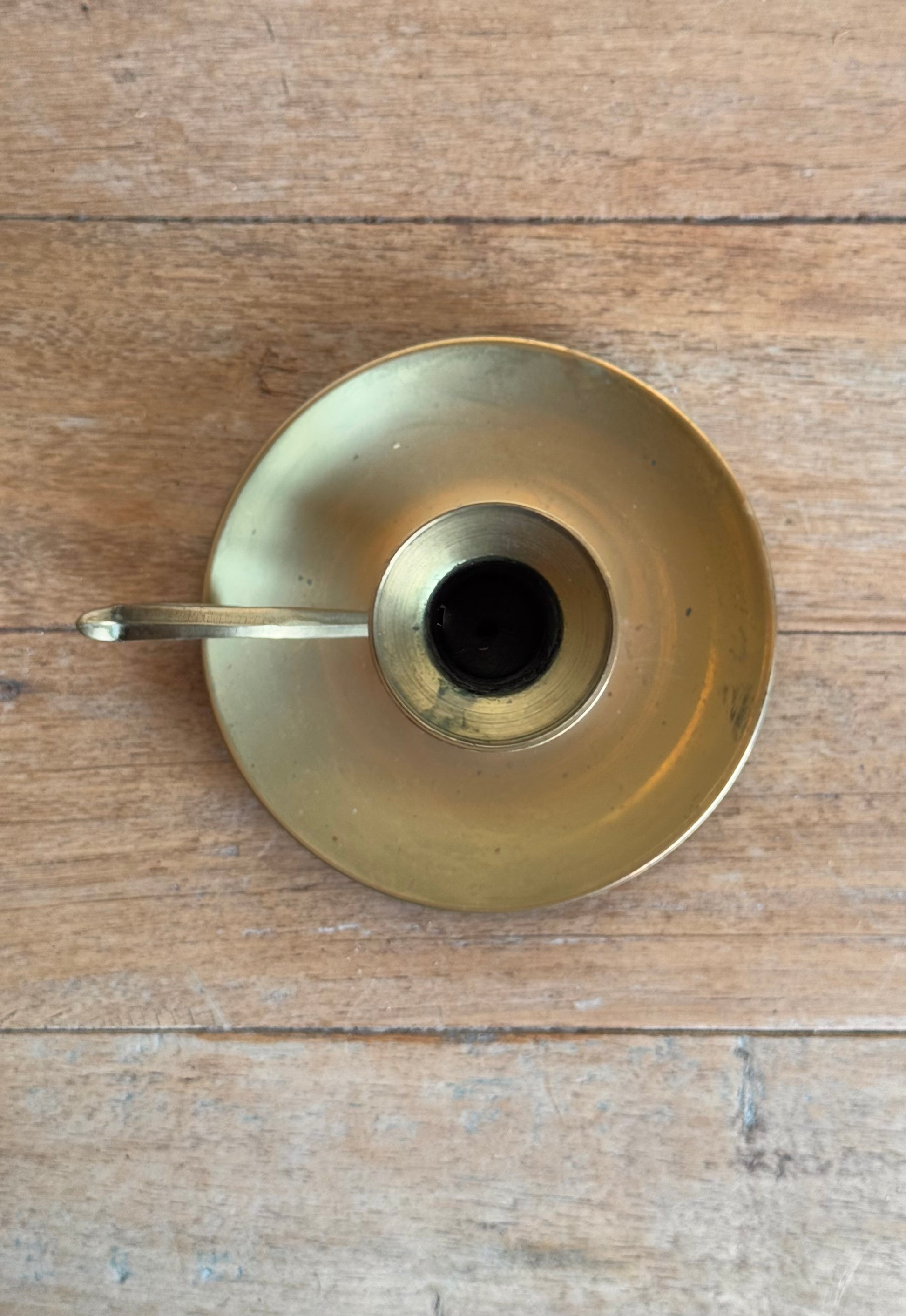 Brass candle holder on a wooden surface