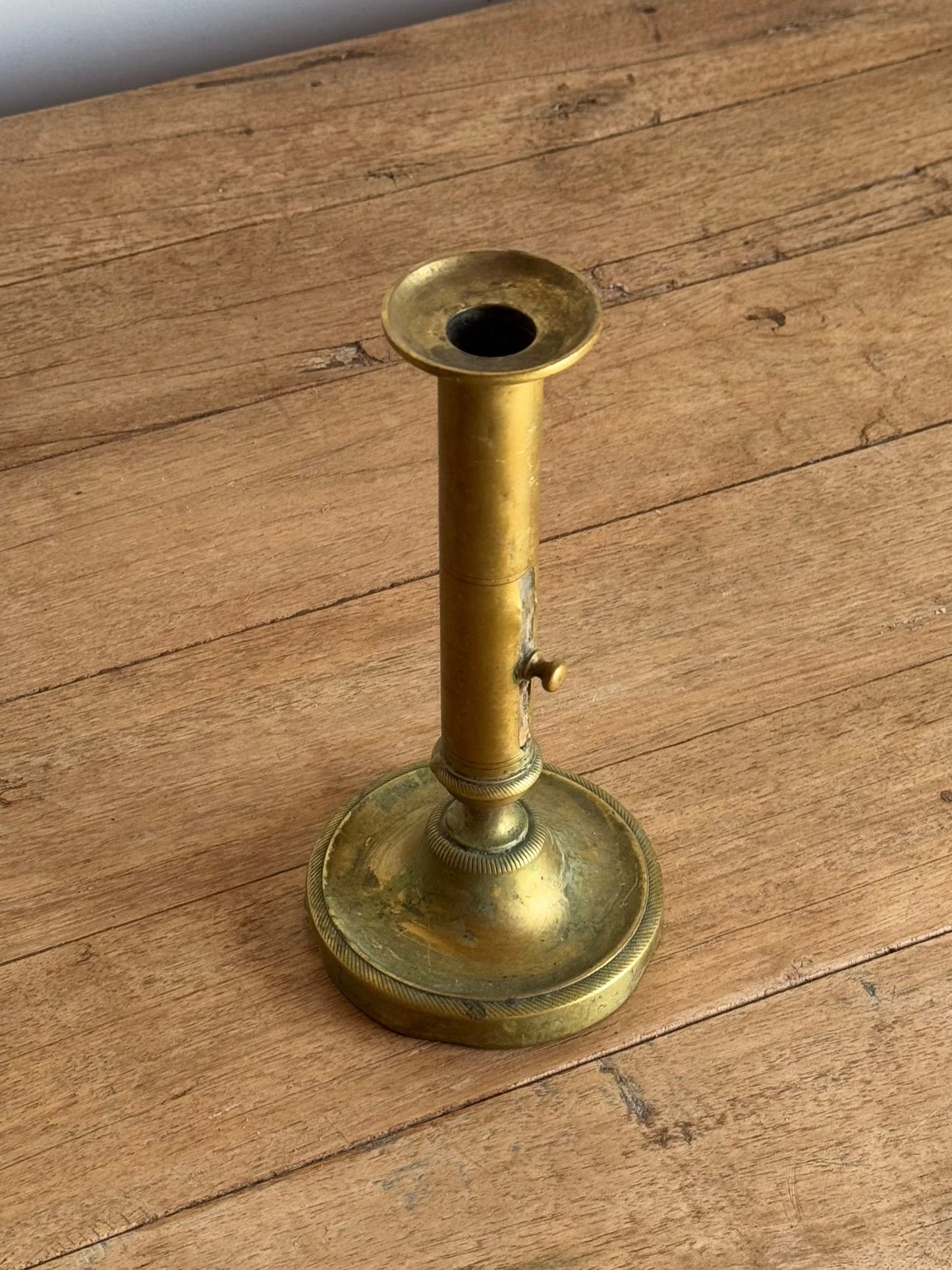 Brass candlestick on a wooden surface