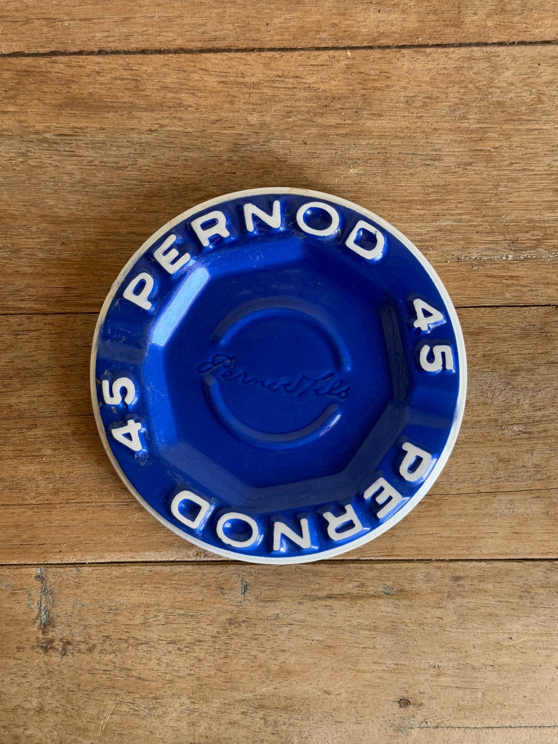 Blue Pernod 45 catch all dish on a wooden surface