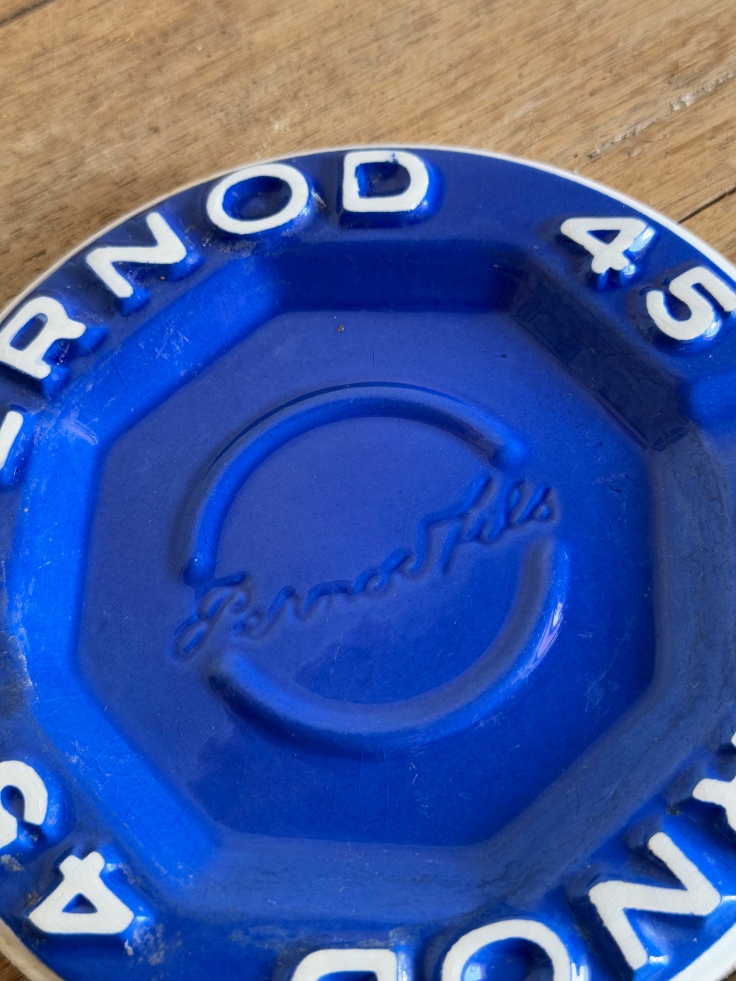 Blue catch all dish with '45' and 'Leyland' branding on a wooden surface