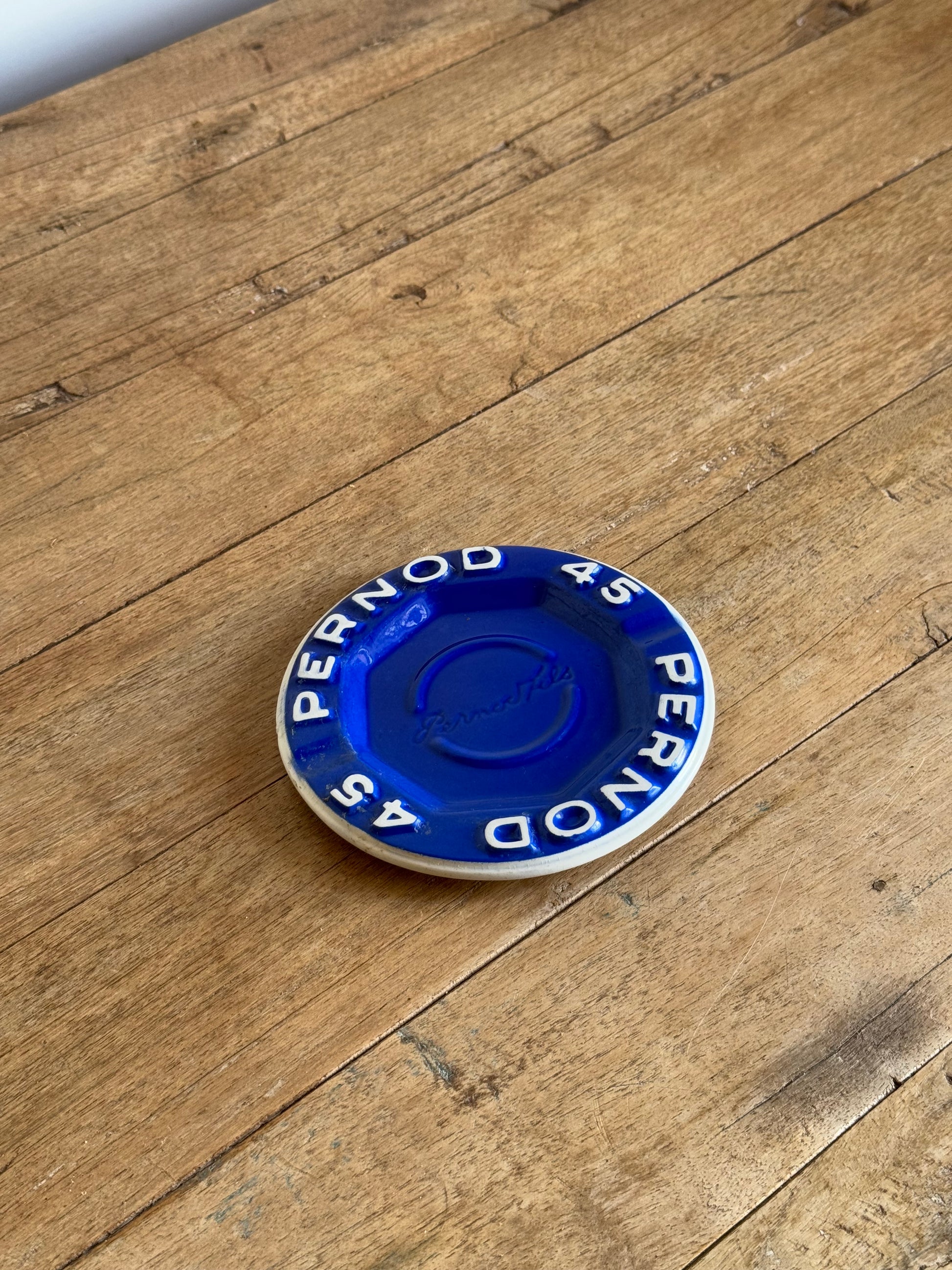 Pernod catch all dish on a wooden surface