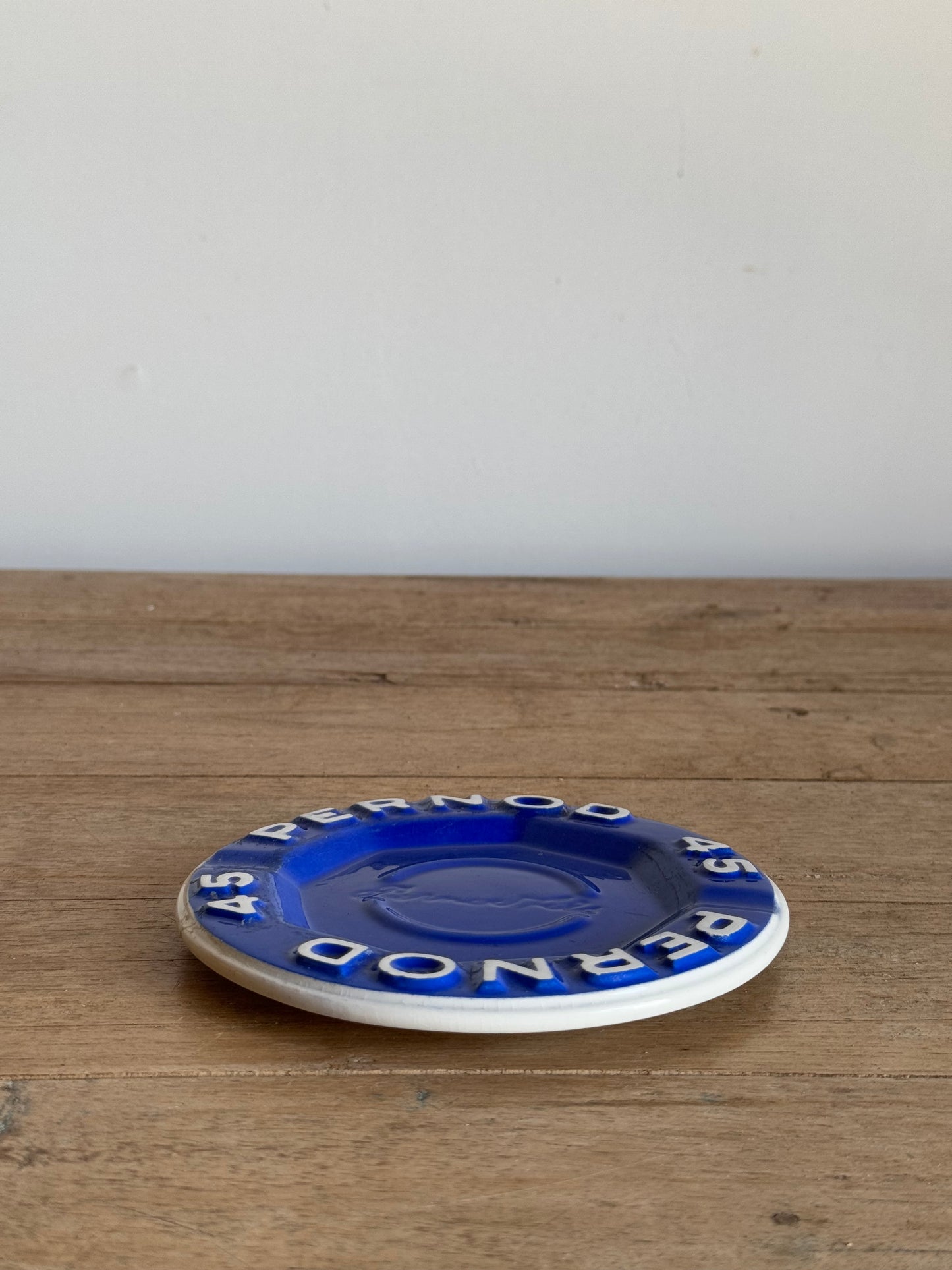 Round blue and white catch all dish on a wood table