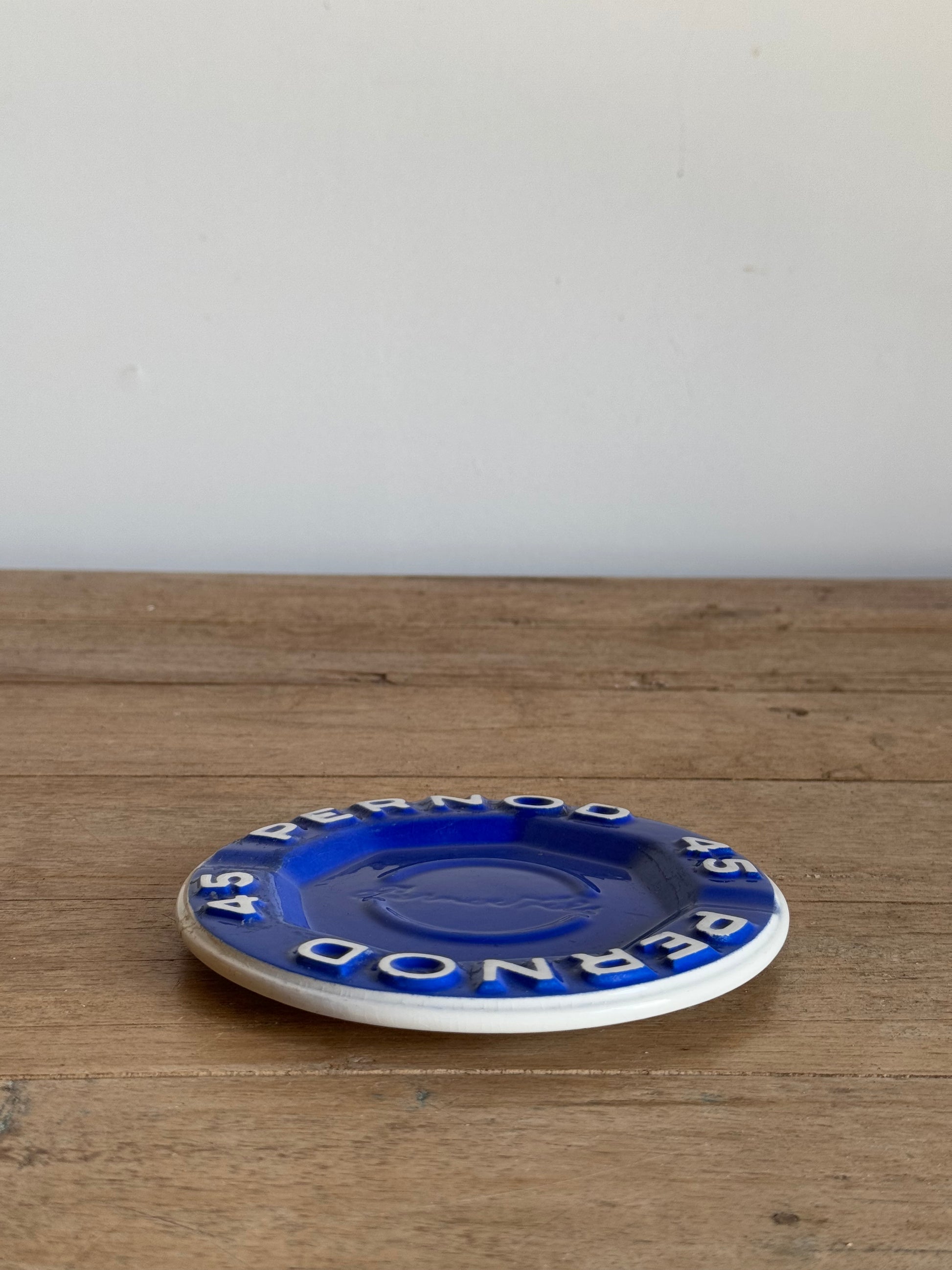 Round blue and white catch all dish on a wood table