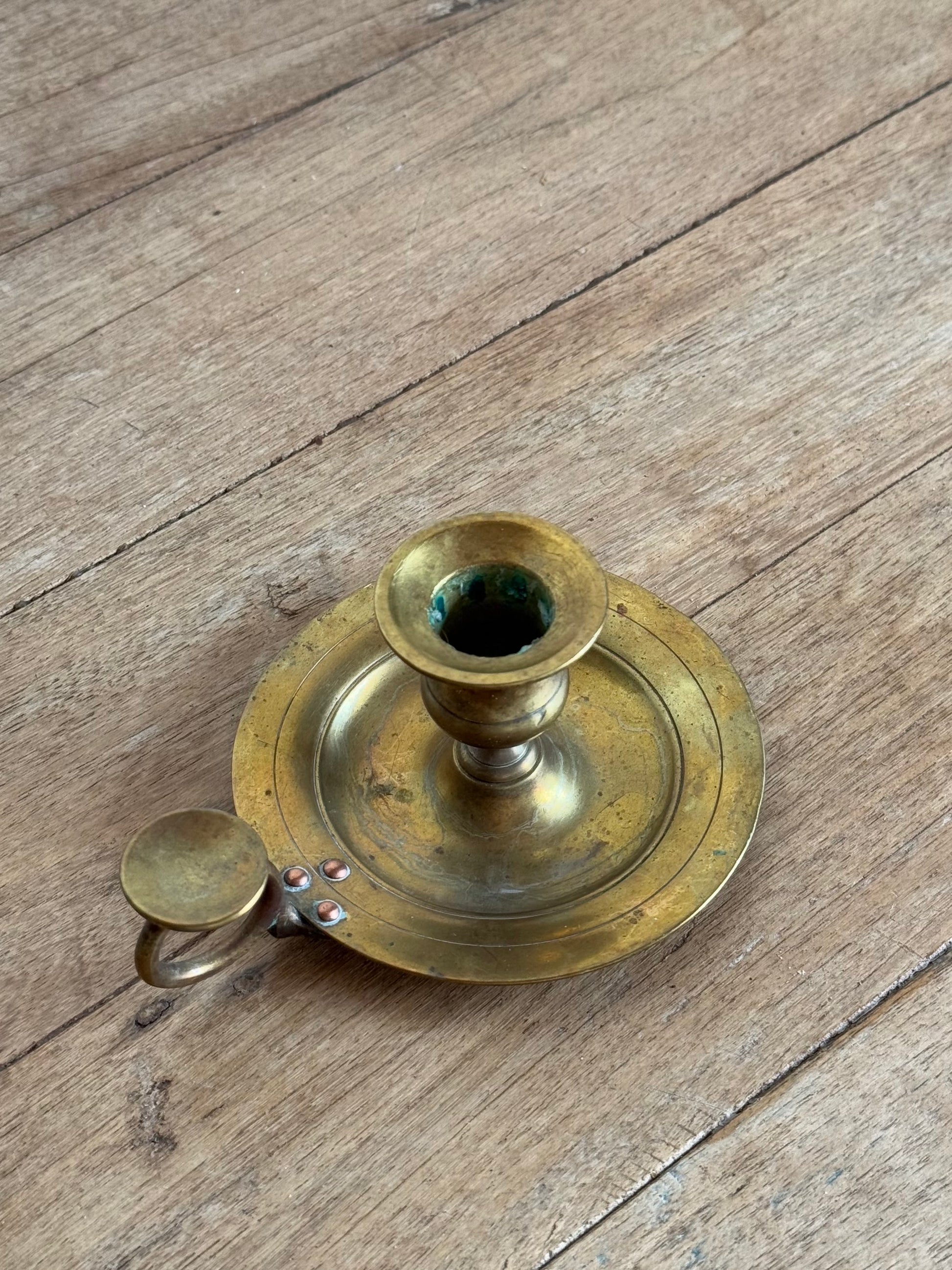 Brass candle holder on a wooden surface