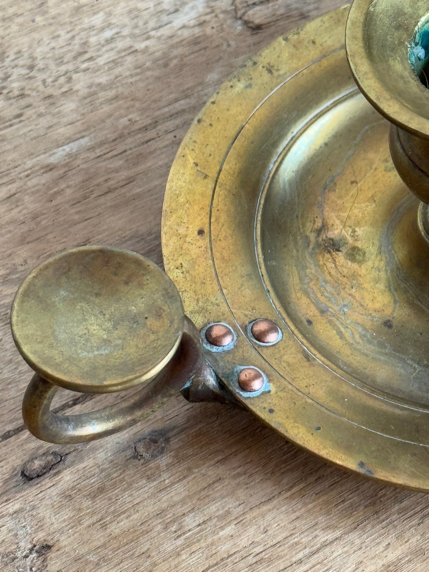 Brass candle holder on a wooden surface