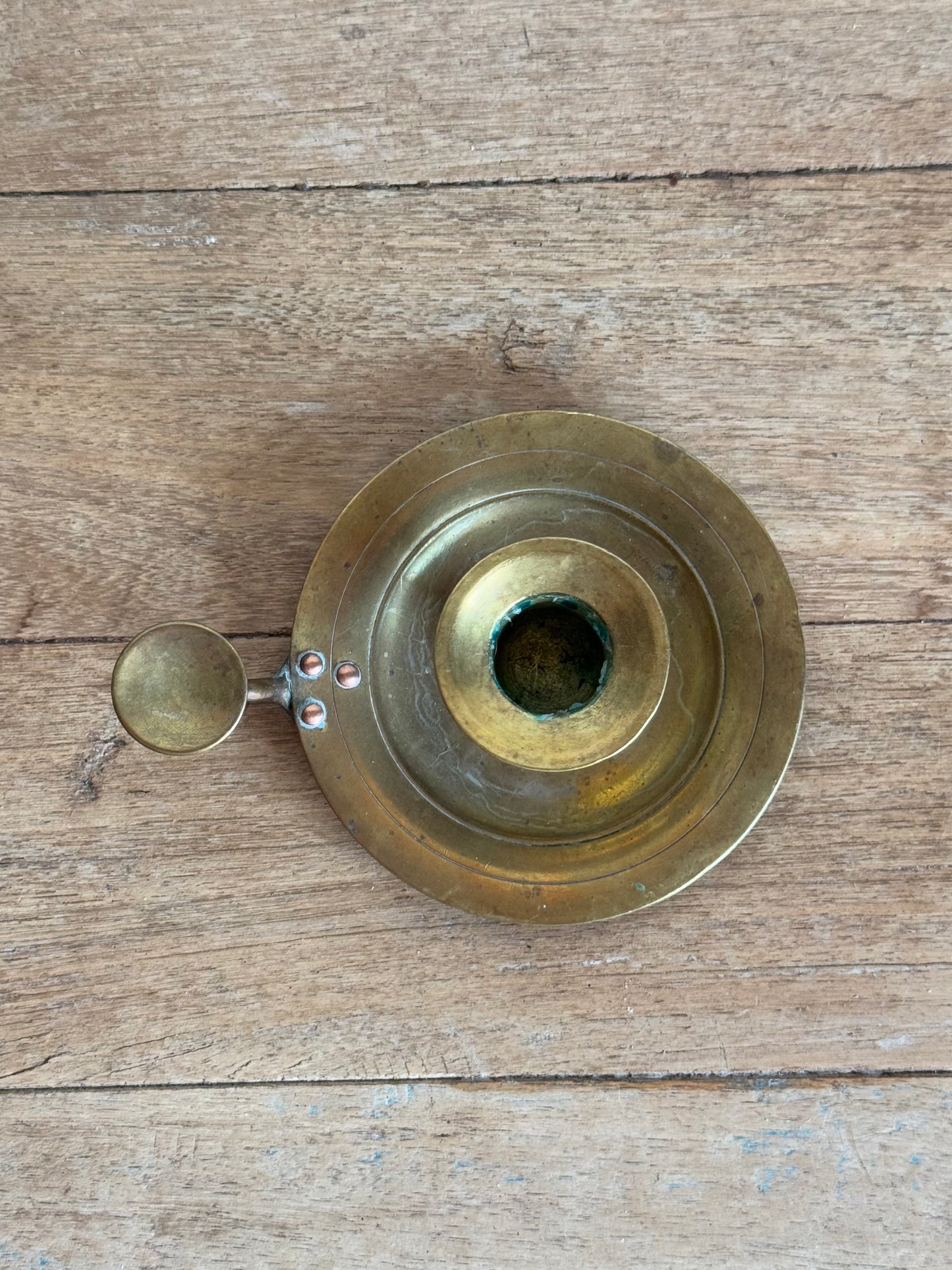 Brass candle holder  on a wooden surface