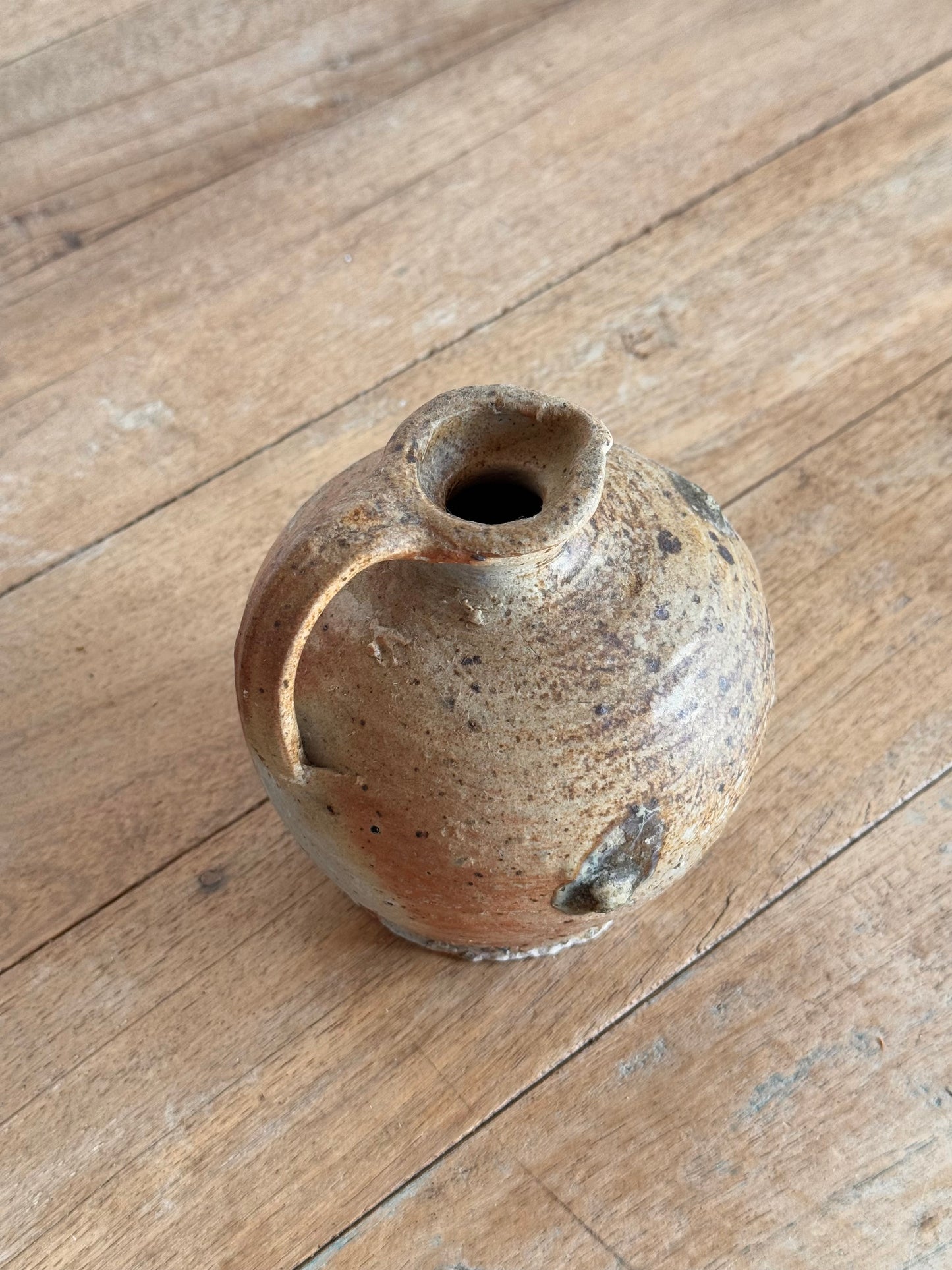 Small ceramic vase on a wooden surface