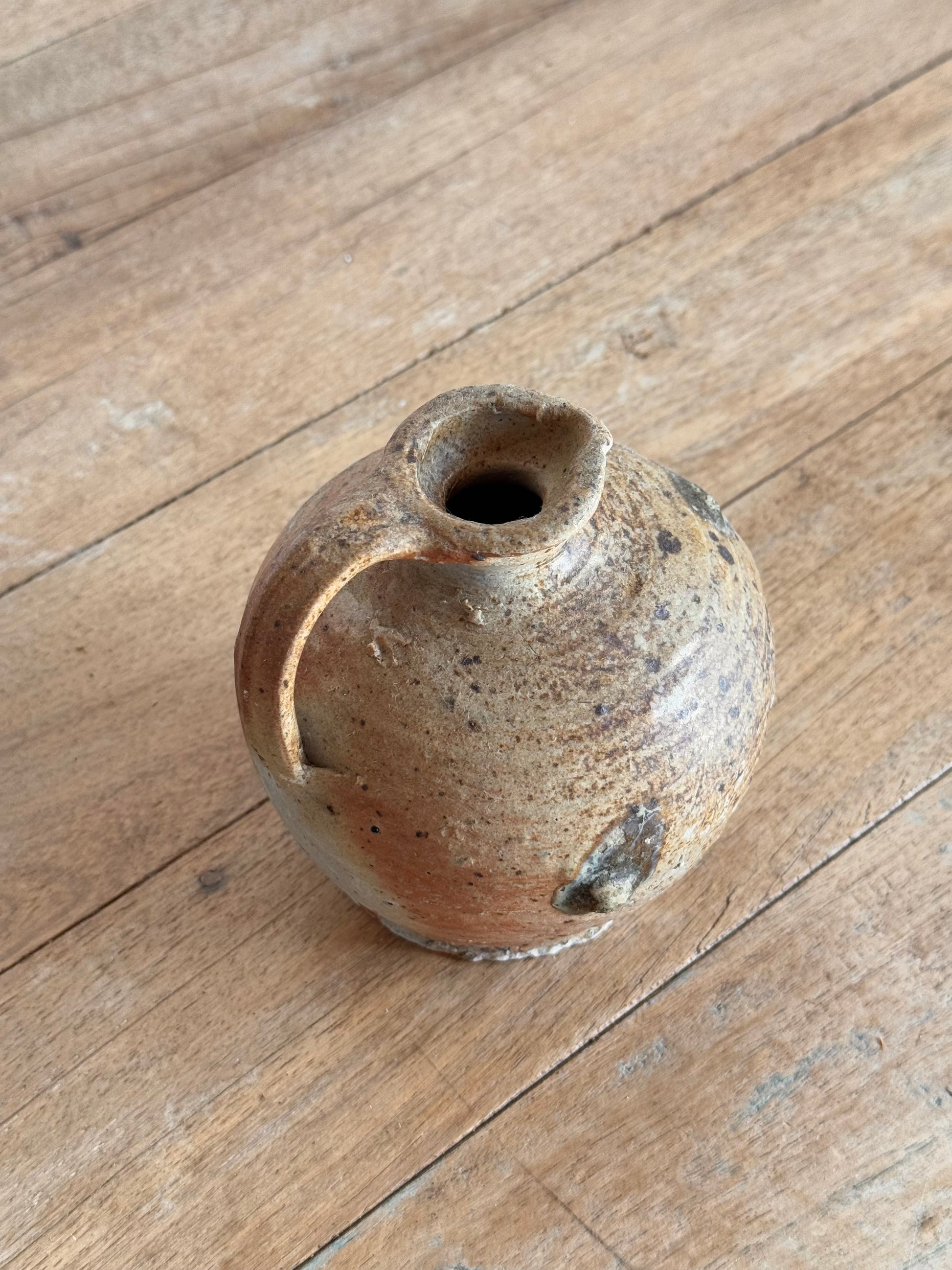 Small ceramic vase on a wooden surface
