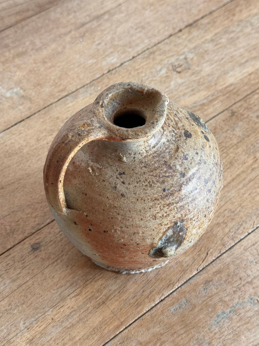 Small ceramic vase on a wooden surface