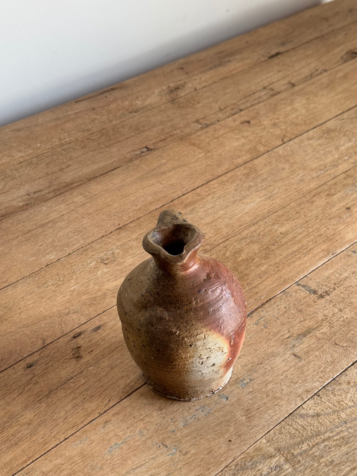 Small ceramic vase on a wooden floor