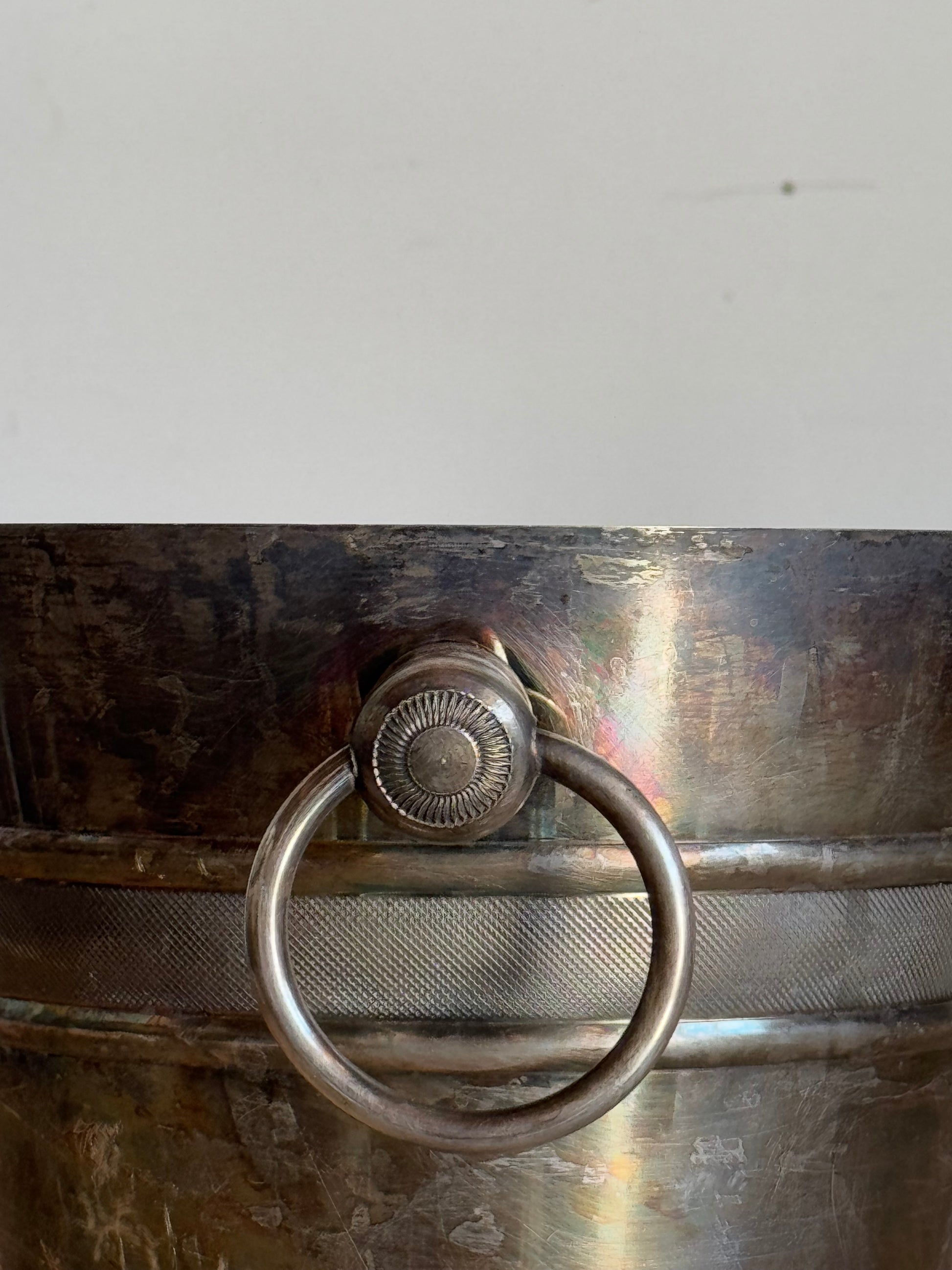 close up of vintage metal ice bucket with rings
