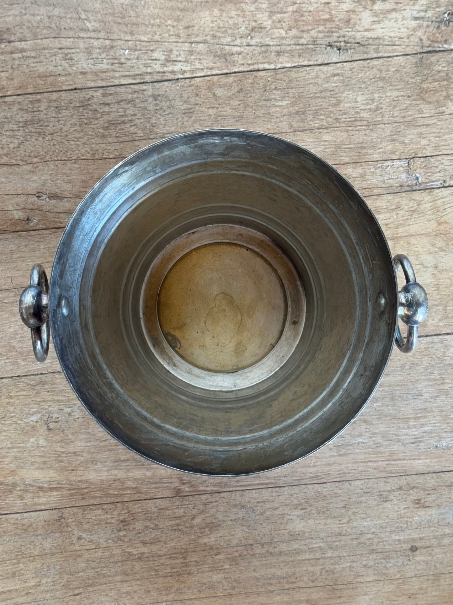 Metal bucket on a wooden surface