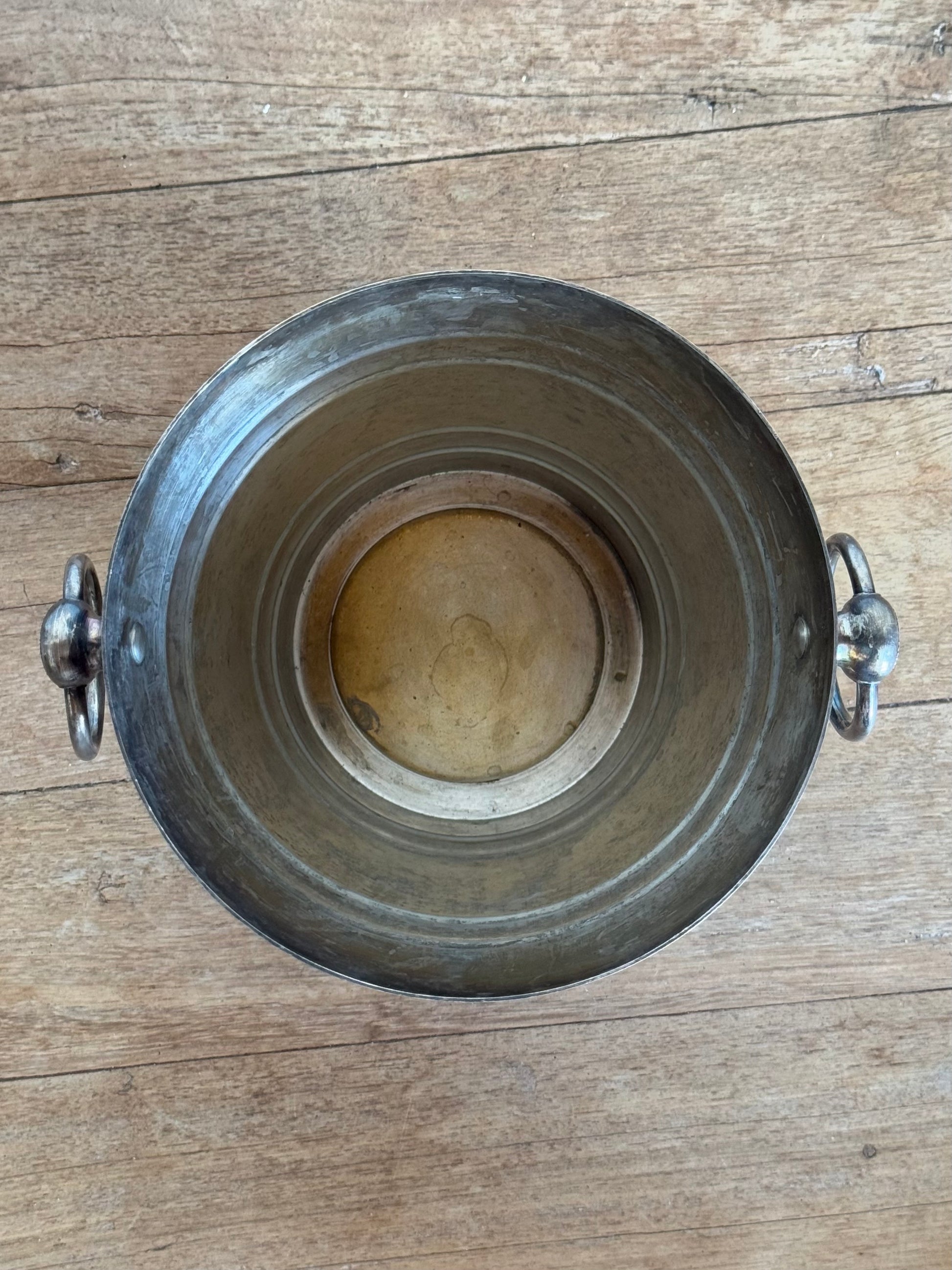 Metal bucket on a wooden surface