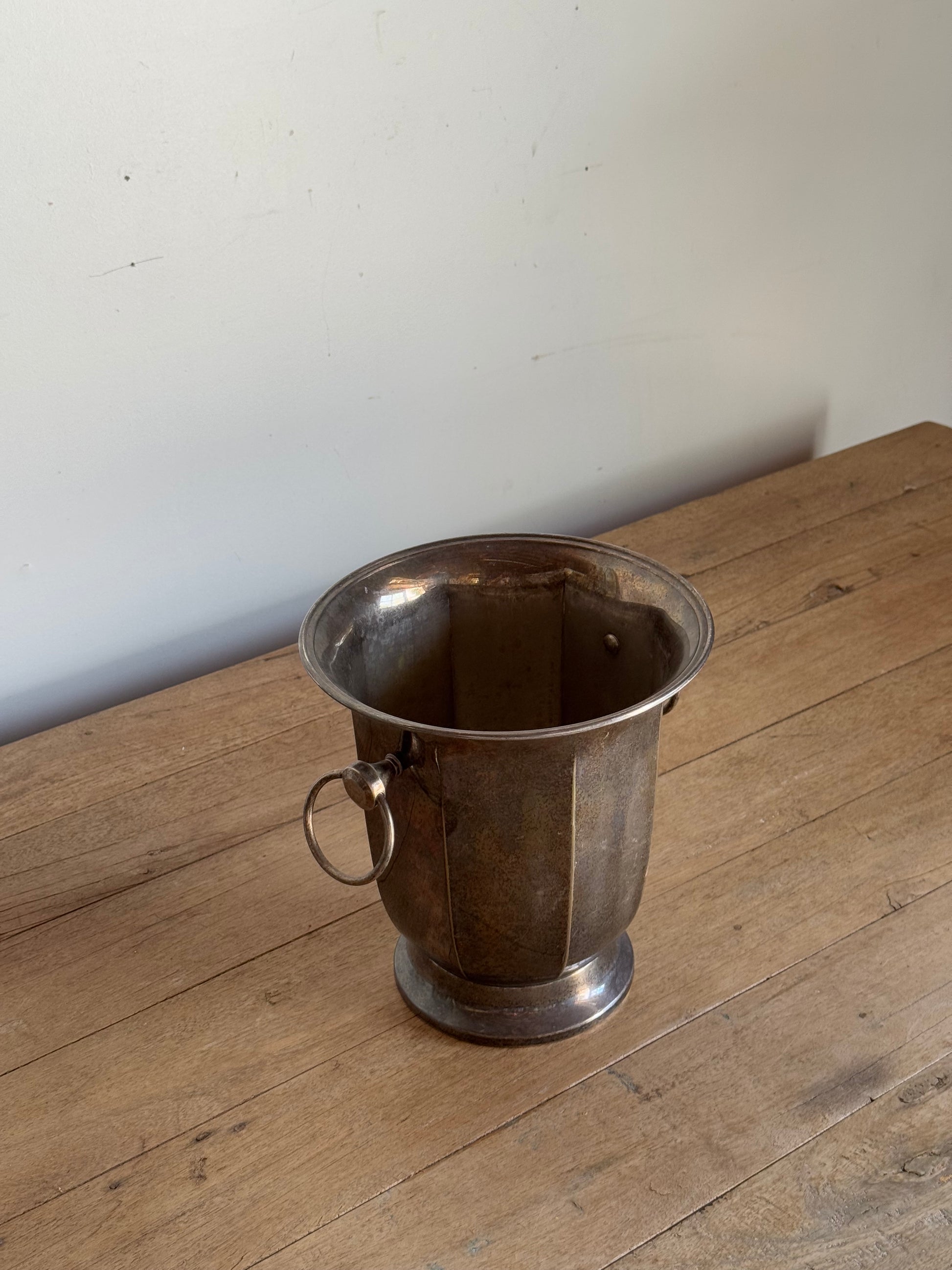 Metal bucket on a wooden floor