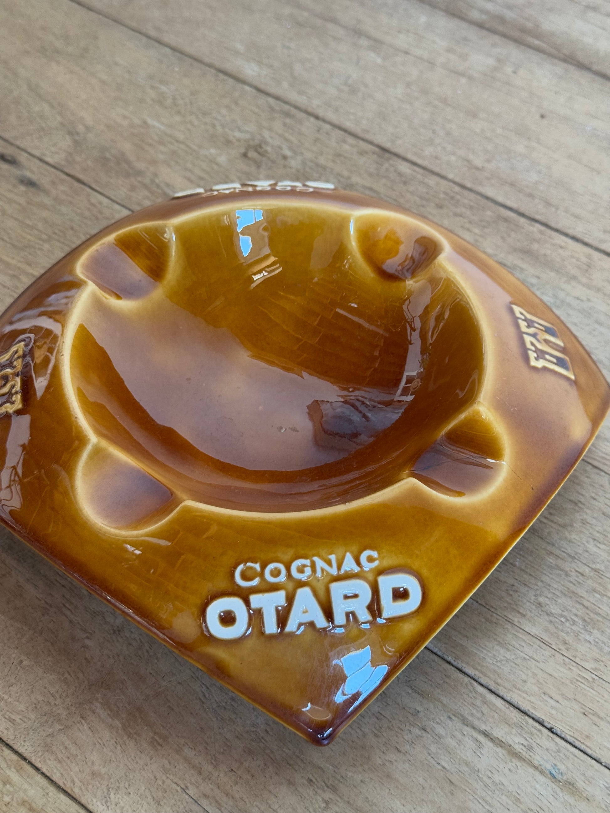 Cognac Otard catch all  on a wooden surface