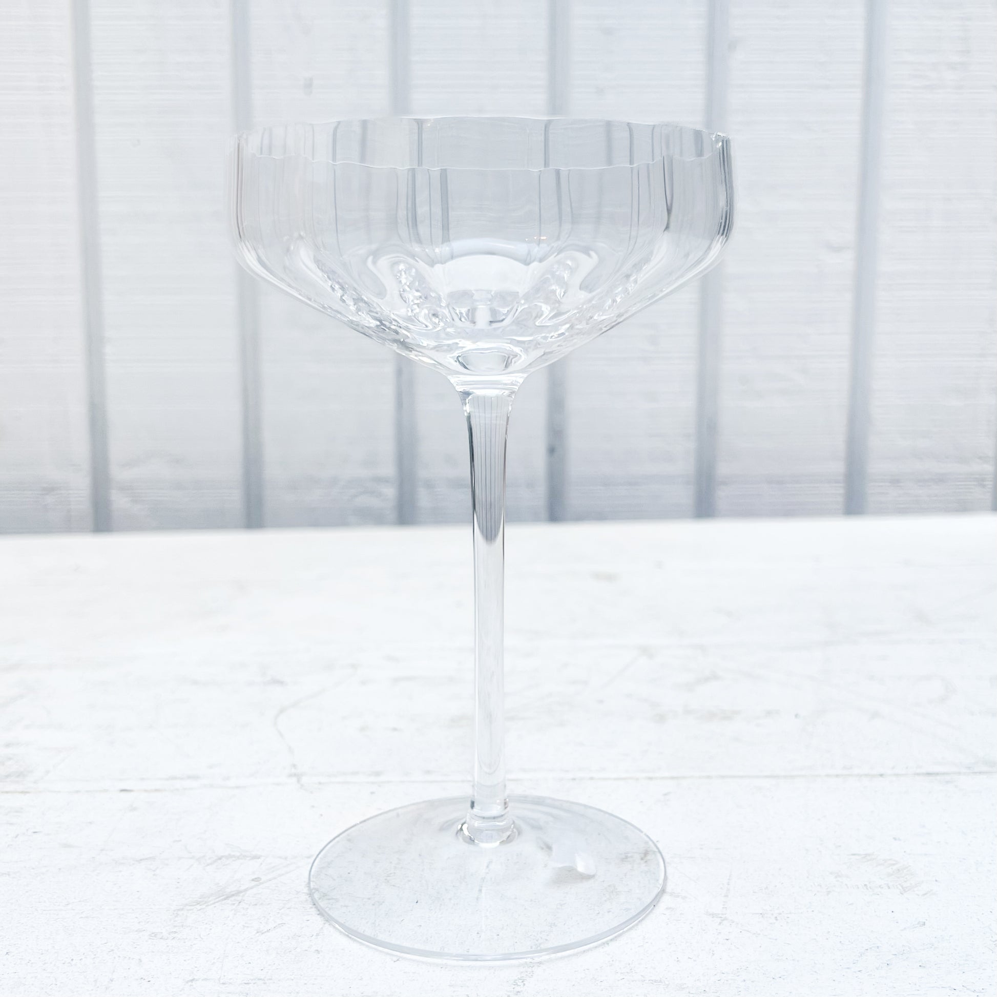 clear coupe shaped  champagne glass with ridges