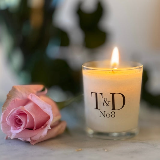 clear glass votive candle with logo label