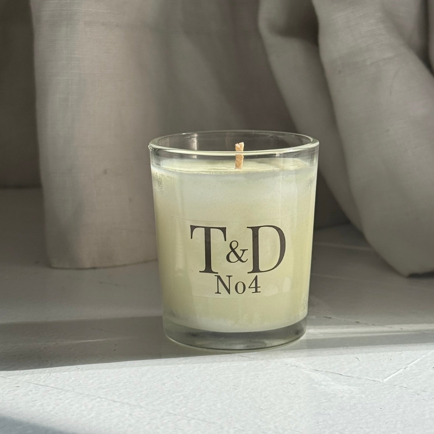 clear glass votive with clear label logo