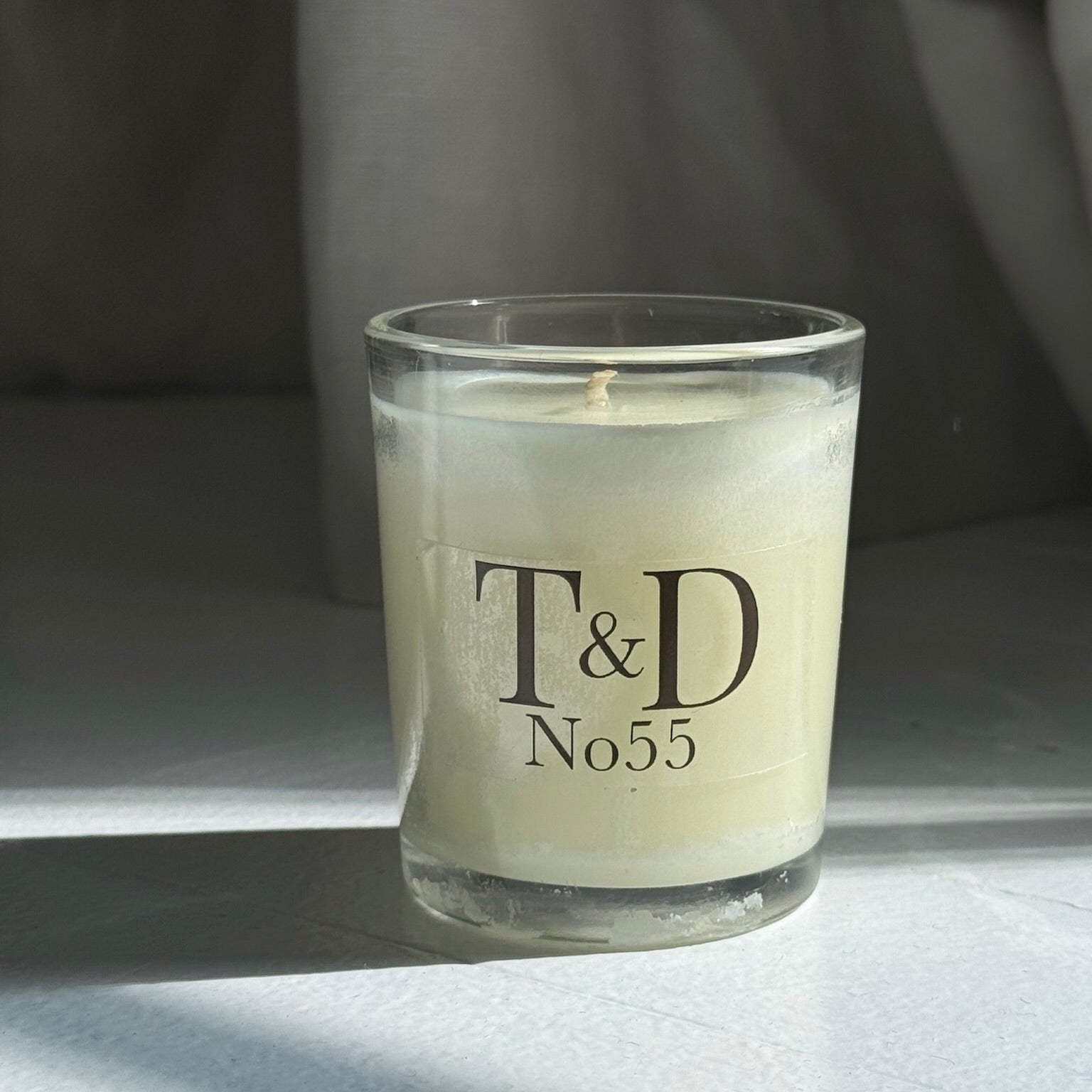 clear glass votive with clear label logo