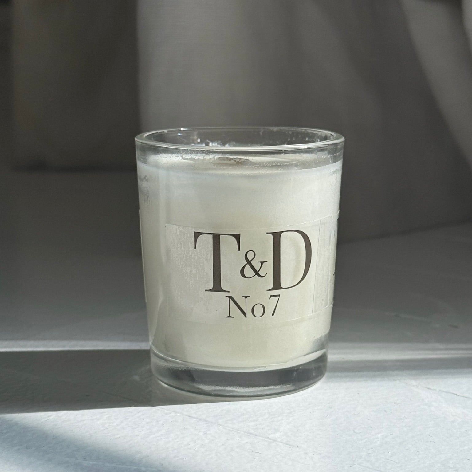 clear glass votive with clear label logo