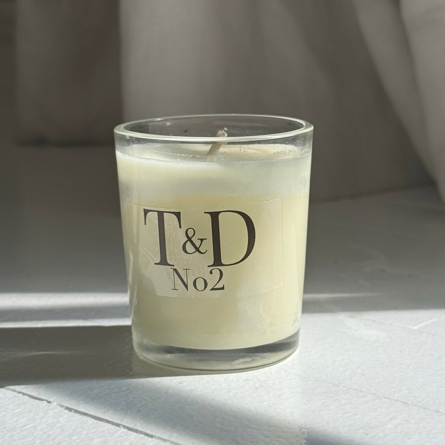 clear glass votive with clear label logo