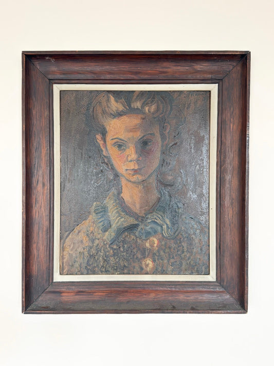 Framed portrait painting of a woman on a white wall