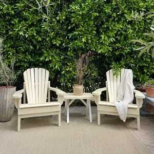 cream colored painted Adirondack chairs and side table