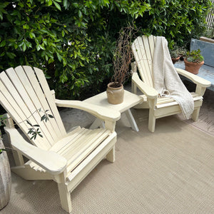 cream colored painted Adirondack chairs and side table