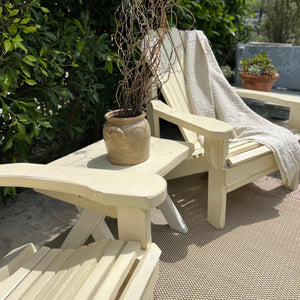 cream colored painted Adirondack chairs and side table