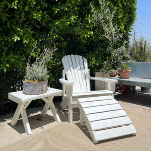 white painted Adirondack chair with ottoman and side table